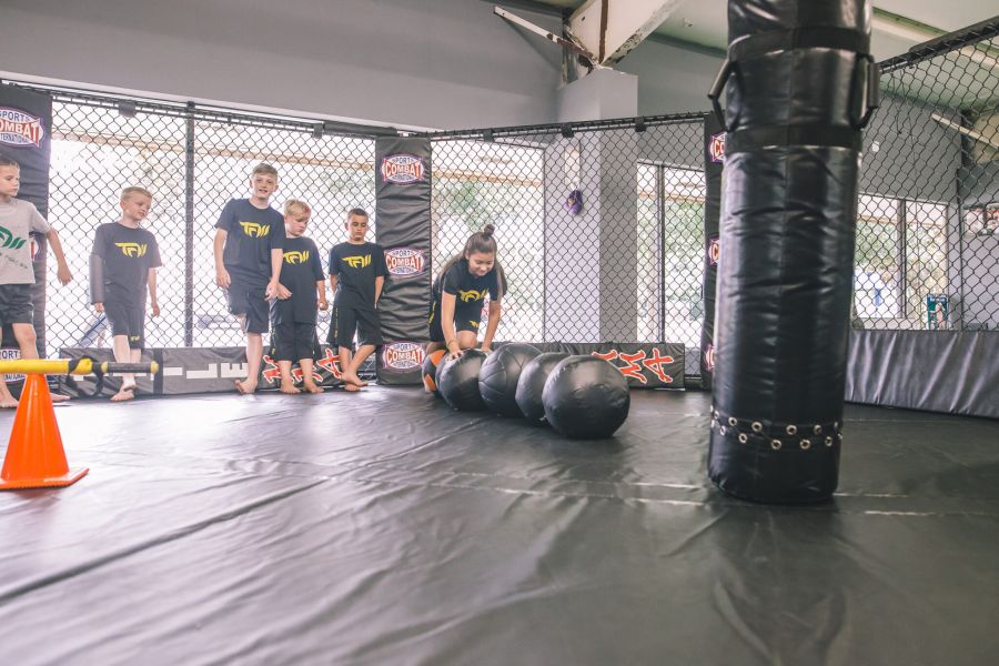 Kids participating in martial arts and kickboxing classes at Train Fight Win gym in Tallahassee during the Spartan Kids Program.